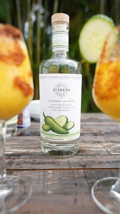 Instagram post by @bellamerlot_ for 21Seeds Infused Tequila. Caption reads: 🌞🍹 #AD Spice up your next summer BBQ with a....