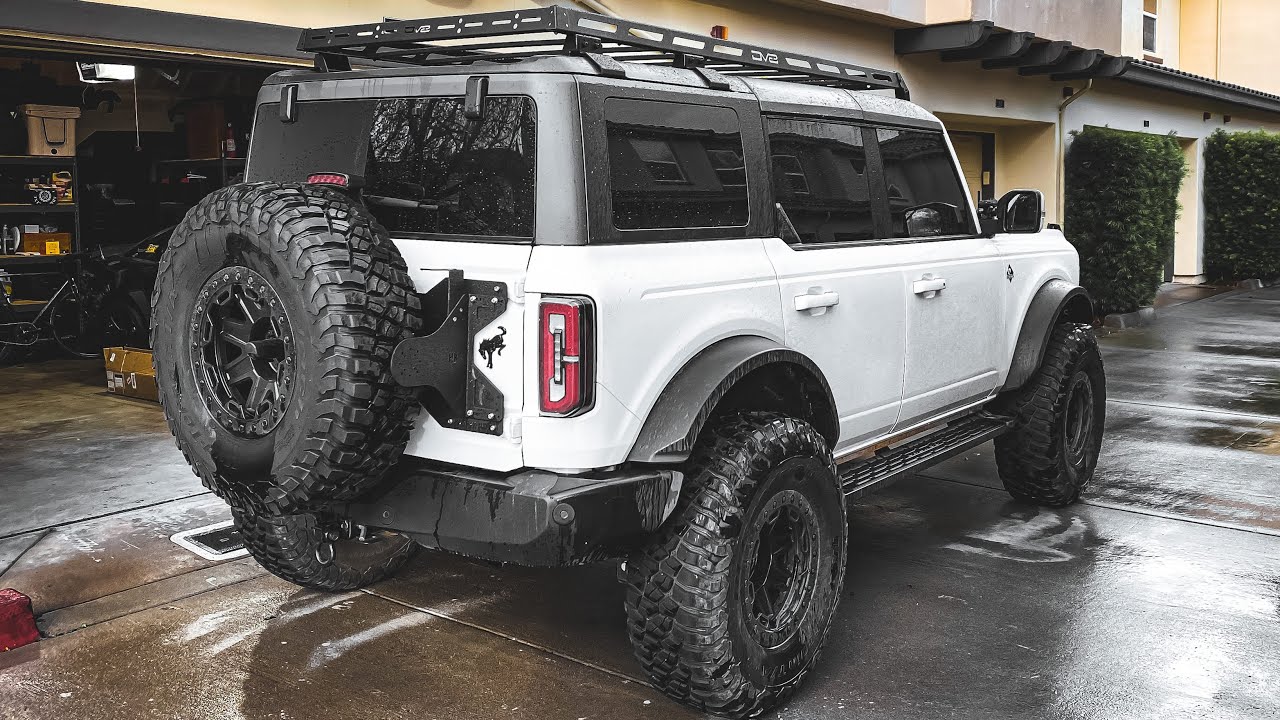 YouTube post by @JacobRDoty for DV8 Offroad. Caption reads: More Bronco Mods - DV8 Roof Rack Install.