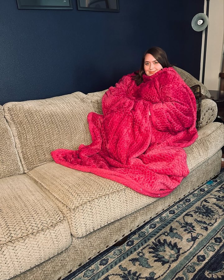 Instagram post by @thisisbecsanne for Snuggie. Caption reads: [...] up all warm and toasty ✨🩷 @officialsnuggie....