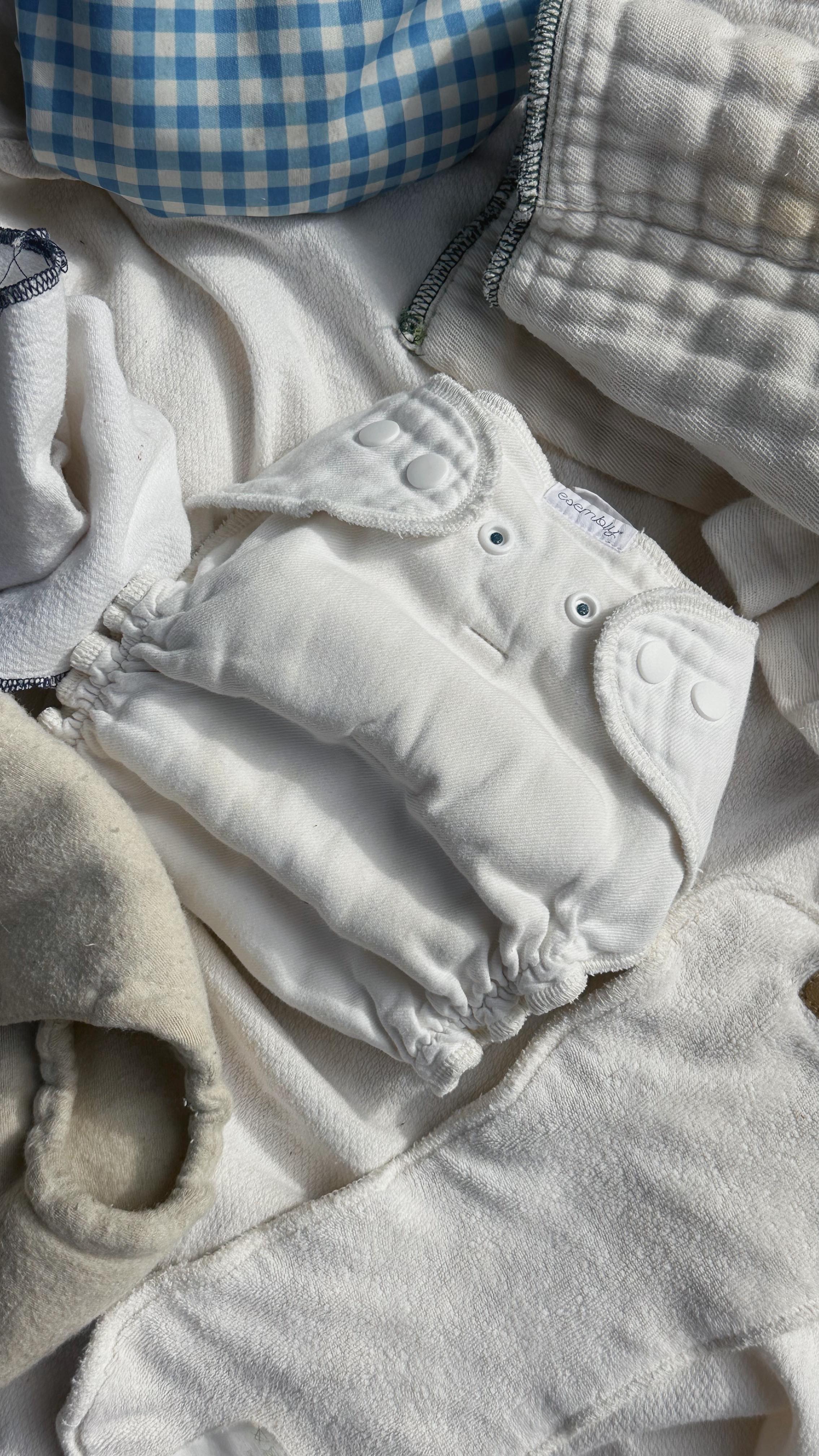 Instagram post by @thetessasmith for Esembly Baby. Caption reads: let’s chat cloth diapering 👼🏻🧺☀️

Comment....