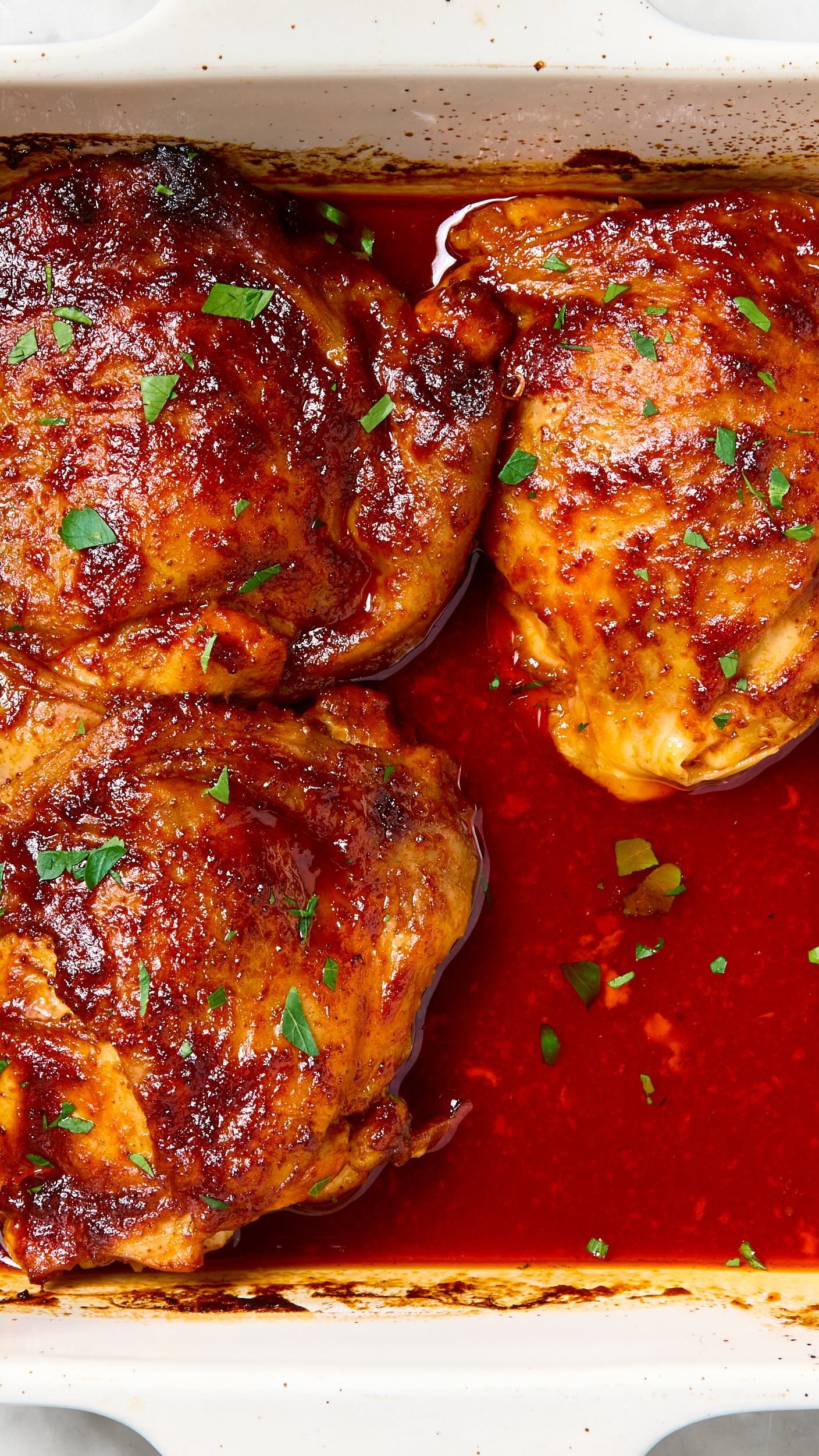 Instagram post by @kellimfoster for The Kitchn. Caption reads: This harissa orange chicken recipe is one we’ve....