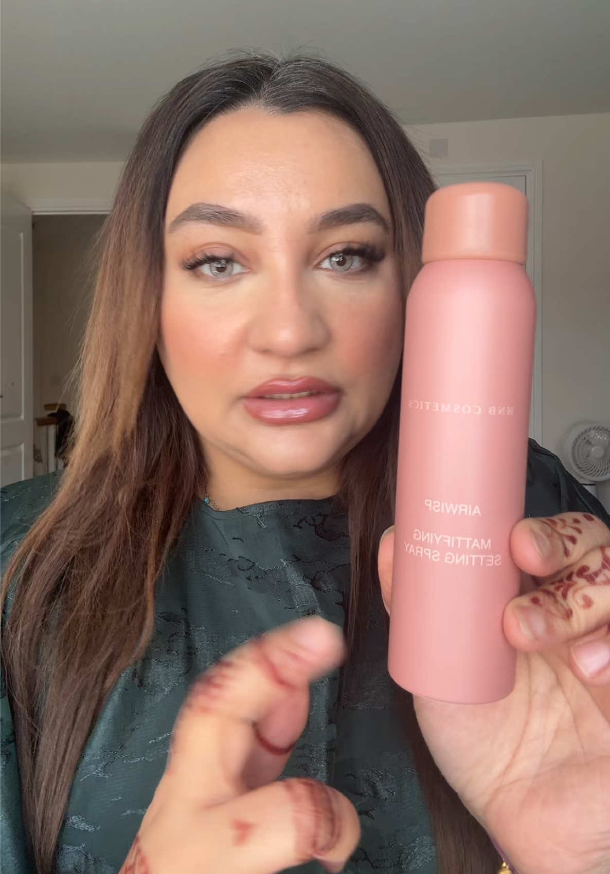 TikTok post by @docnafiakhan for HNB Cosmetics. Caption reads: [...] like a heavy duty setting spray! @HNB....