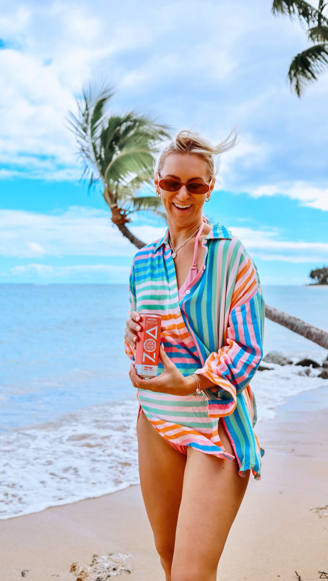 Instagram post by @thealohablonde for ZOA Energy. Caption reads: From @costco hauls ➝ beach adventures ➝ pool days,....