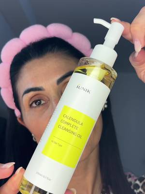 TikTok post by @tizy.e82 for IUNIK. Caption reads: [...] oil + calendula balancing foam cleanser....