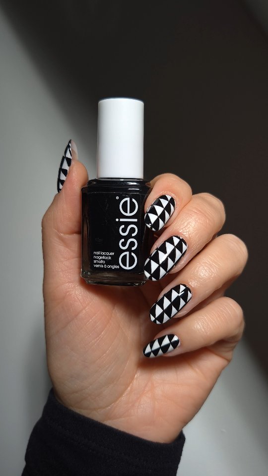 Instagram post by @rebekahxpritchard for essie. Caption reads: Ad Spooky illusion nails with @essie 🎃👻

Shades....