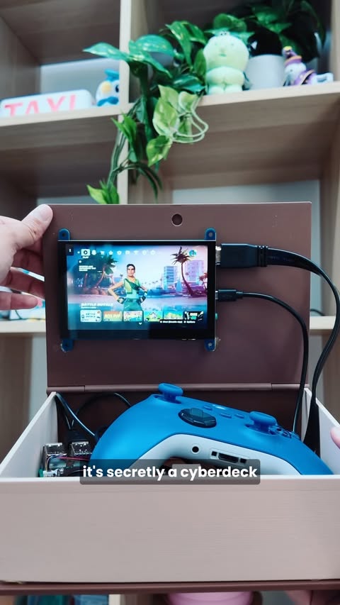 Instagram post by @mewtru for Fortnite. Caption reads: [...] a book into a cyberdeck that plays Fortnite!....