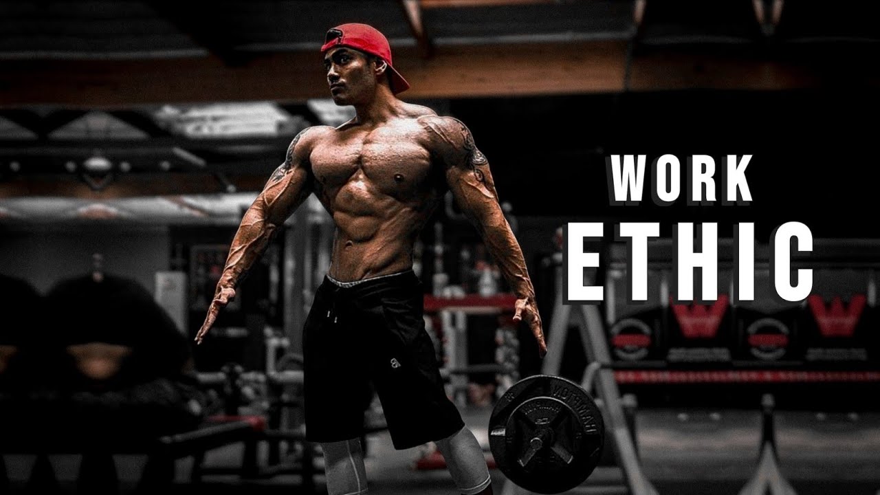 YouTube post by @MuscleBrawn for ENHANCED Labs. Caption reads: WORK ETHIC 😡 Gym Motivation.