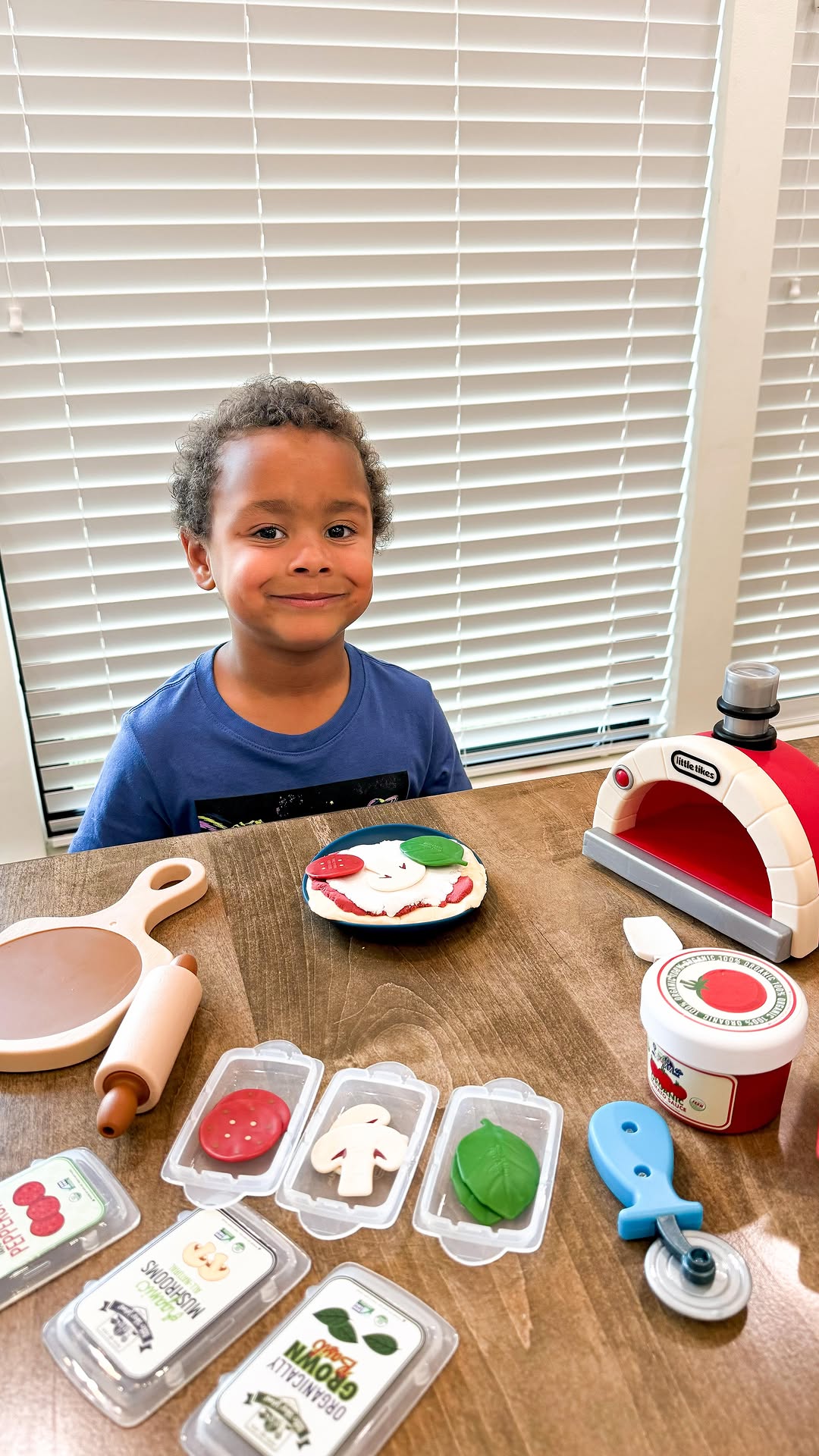 Instagram post by @ahalfbakedmom for Little Tikes. Caption reads: #AD | 🍕✨ DJ is having an absolute blast with his....