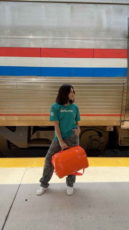 Instagram post by @thriftedbycozy for Baboon To The Moon. Caption reads: me 🤝🏽 @baboontothemoon orange mini go bag 🧡....