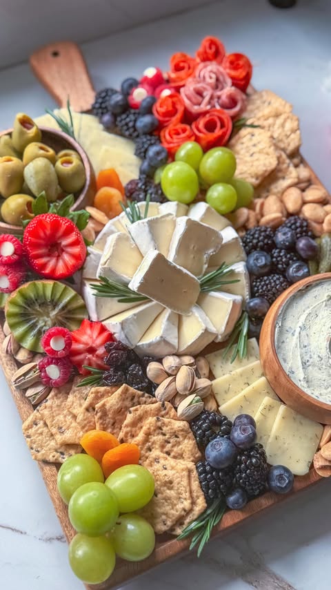Instagram post by @charcuterie_n_things for Crunchmaster Crackers. Caption reads: [...] pair it with something crunchy—....