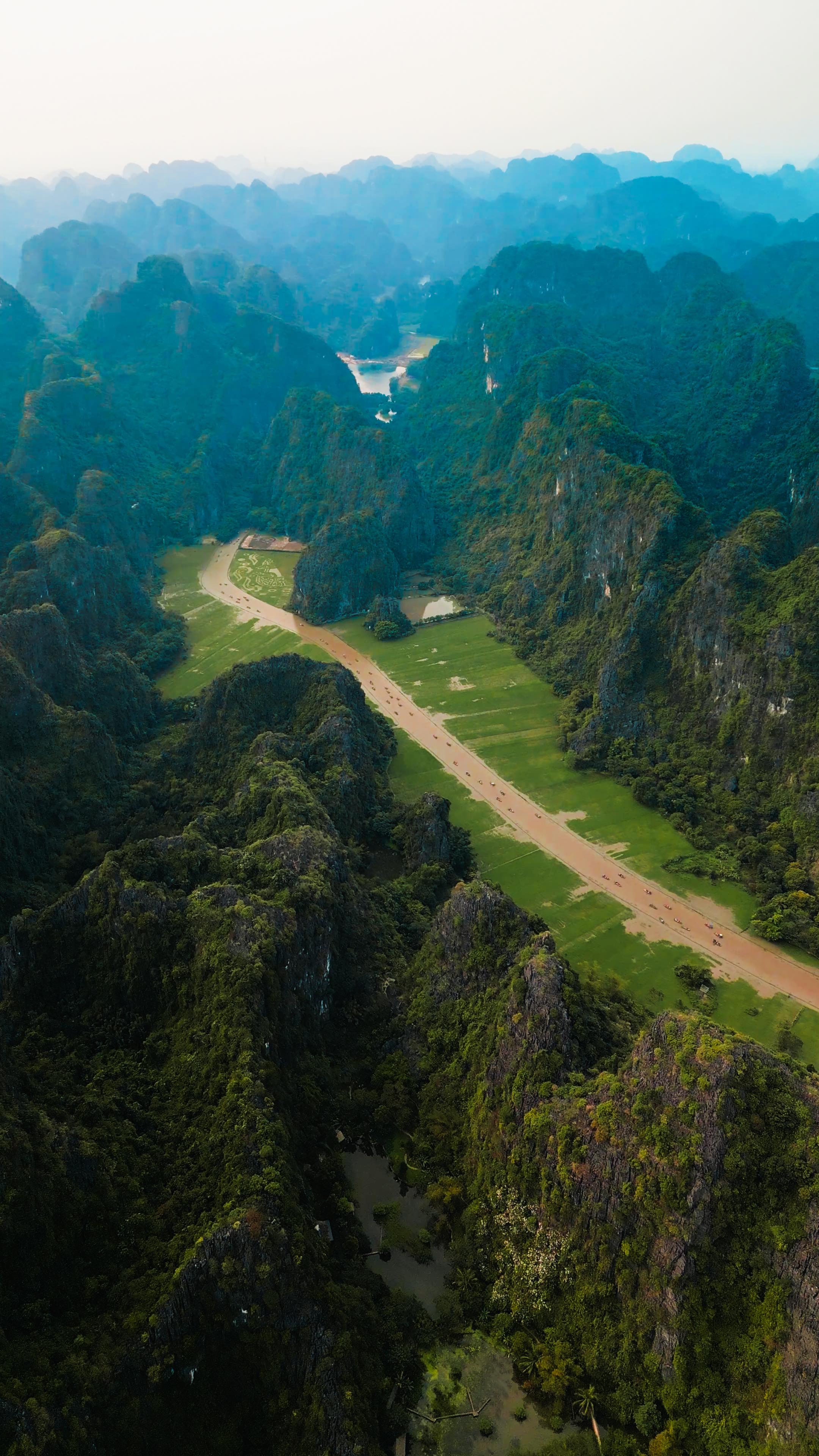 Instagram post by @nicko.stark for EARTH OFFICIAL. Caption reads: Welcome to Tam Cốc, Ninh Bình, Vietnam 🇻🇳

A....