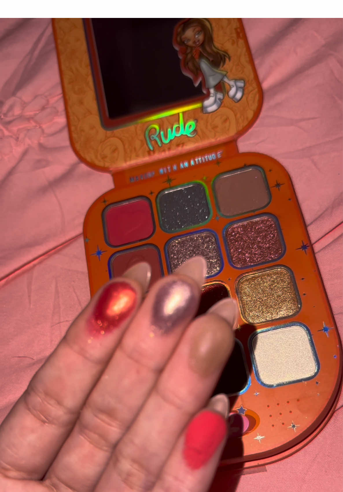 TikTok post by @bri.ana.marie for Bratz. Caption reads: [...] put this on my face😍 @rudecosmetics x....