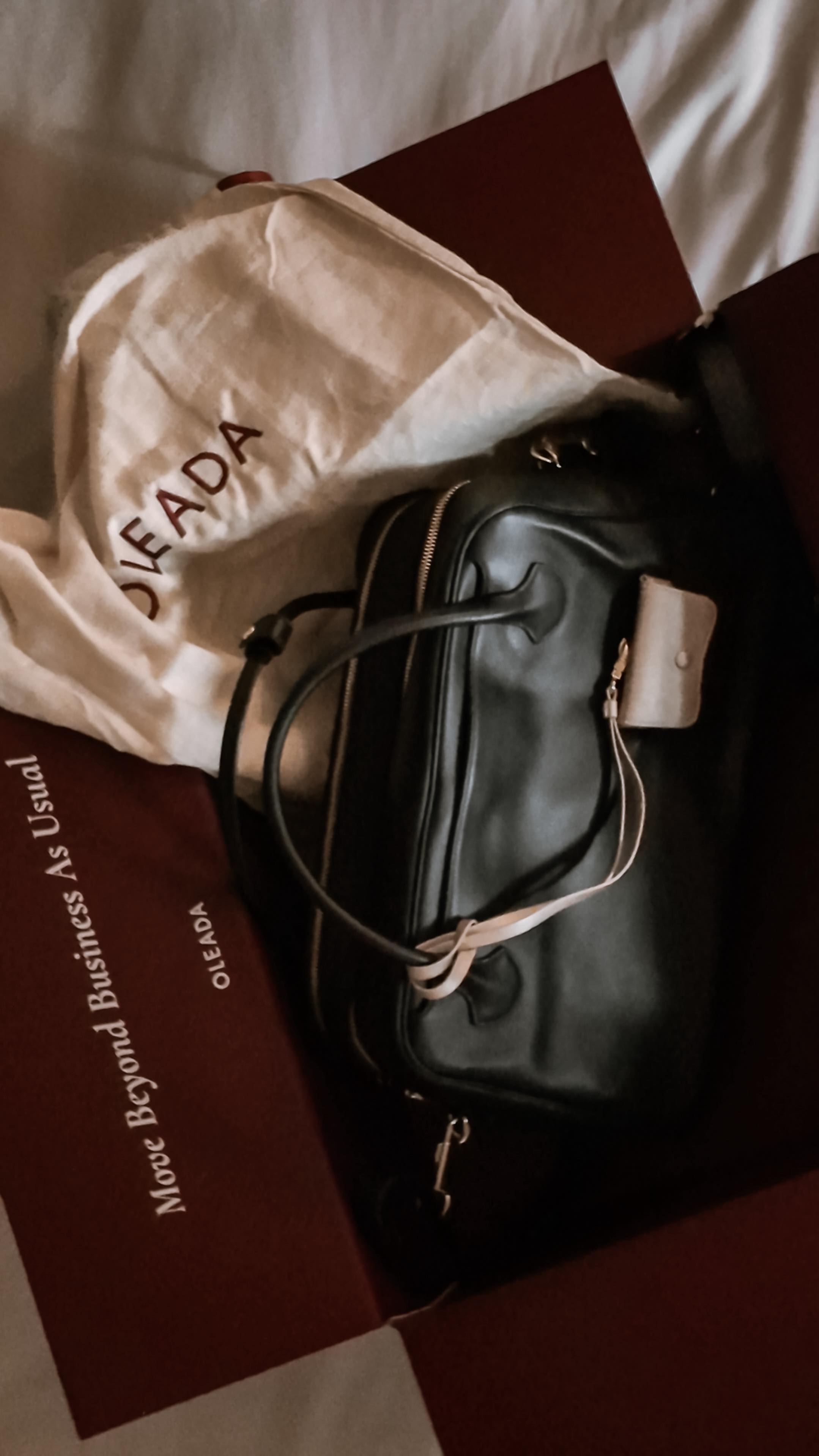 Instagram post by @ajda.nyc for OLEADA. Caption reads: [...] styling, the Marina Carryall by....