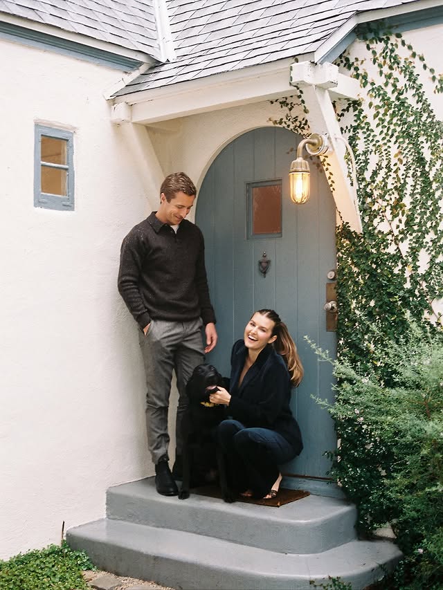 Instagram post by @styledsara for Sezane. Caption reads: Happy Holidays in @sezane 🕯️🐾
Love: Sara, Joe &....