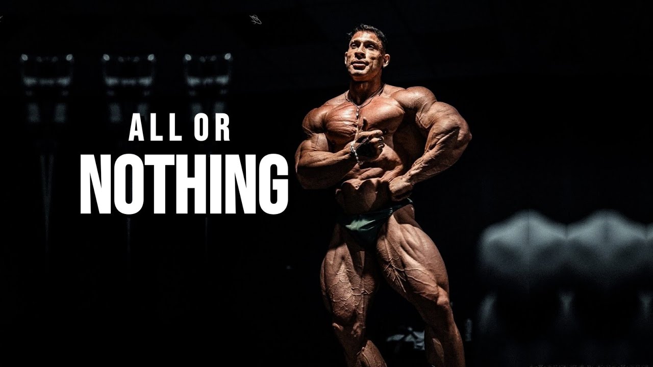 YouTube post by @MuscleBrawn for ENHANCED Labs. Caption reads: F*CK IT ALL OR NOTHING 😡 Gym Motivation.