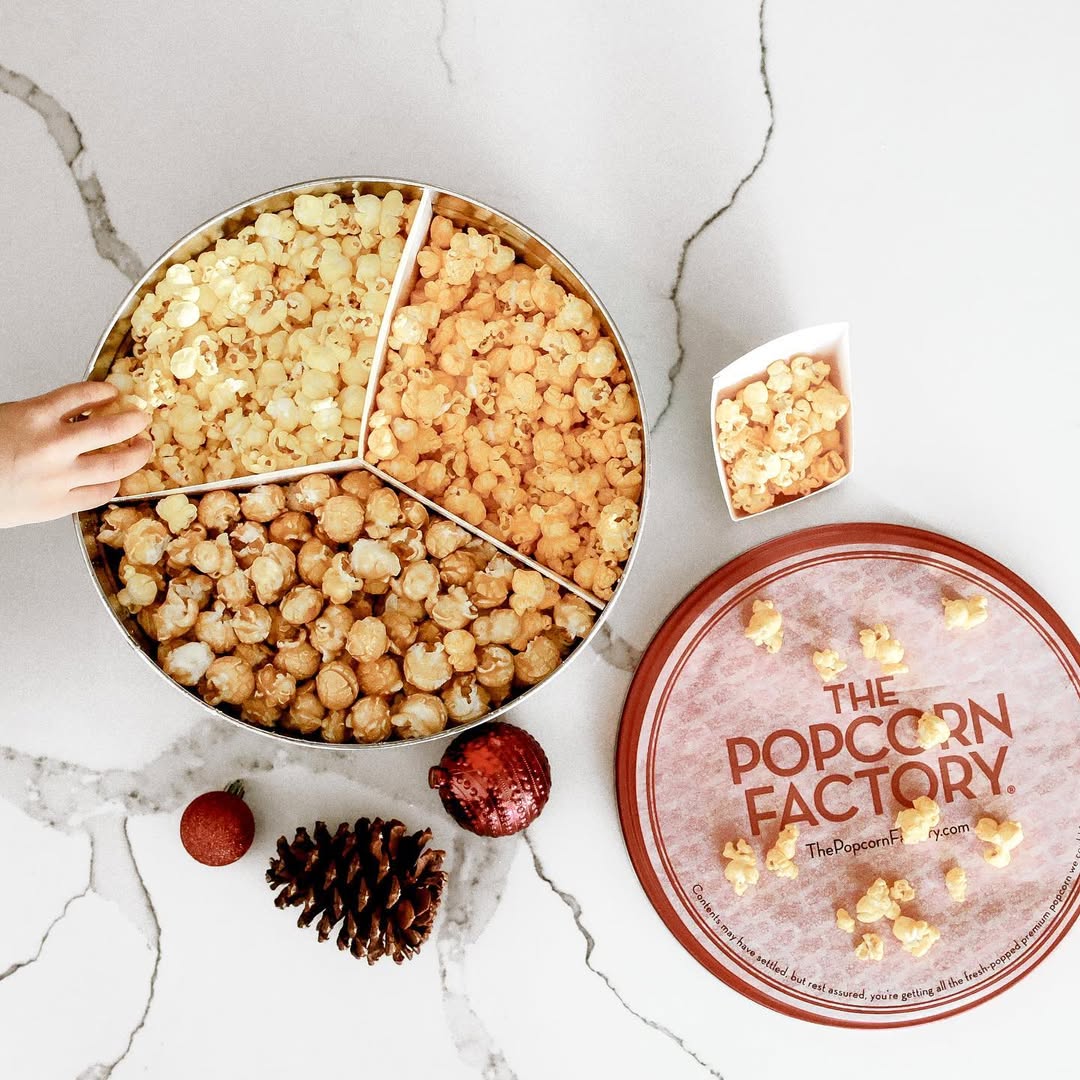 Instagram post by @ashleyxdenise for The Popcorn Factory. Caption reads: Christmas movies and popcorn please. 🤪🍿

Give a....