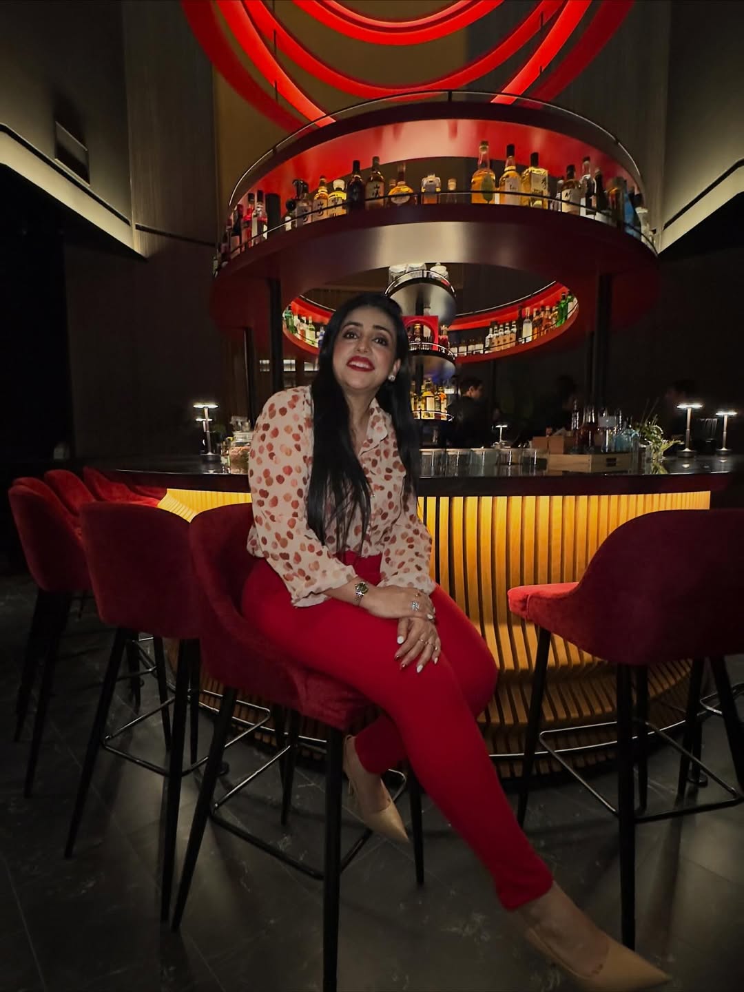 Instagram post by @lavanyavikram_ for Visit Dubai. Caption reads: Red is a statement & this shirt adds all the glam....