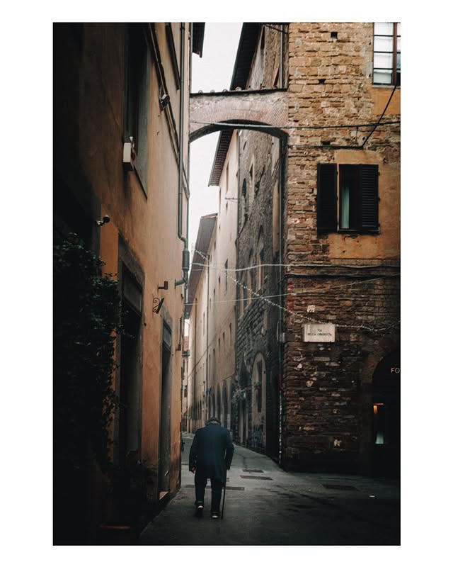 Instagram post by @bobbyanwar for Leica Camera. Caption reads: Some streets move slower than time. Florence. Shot....