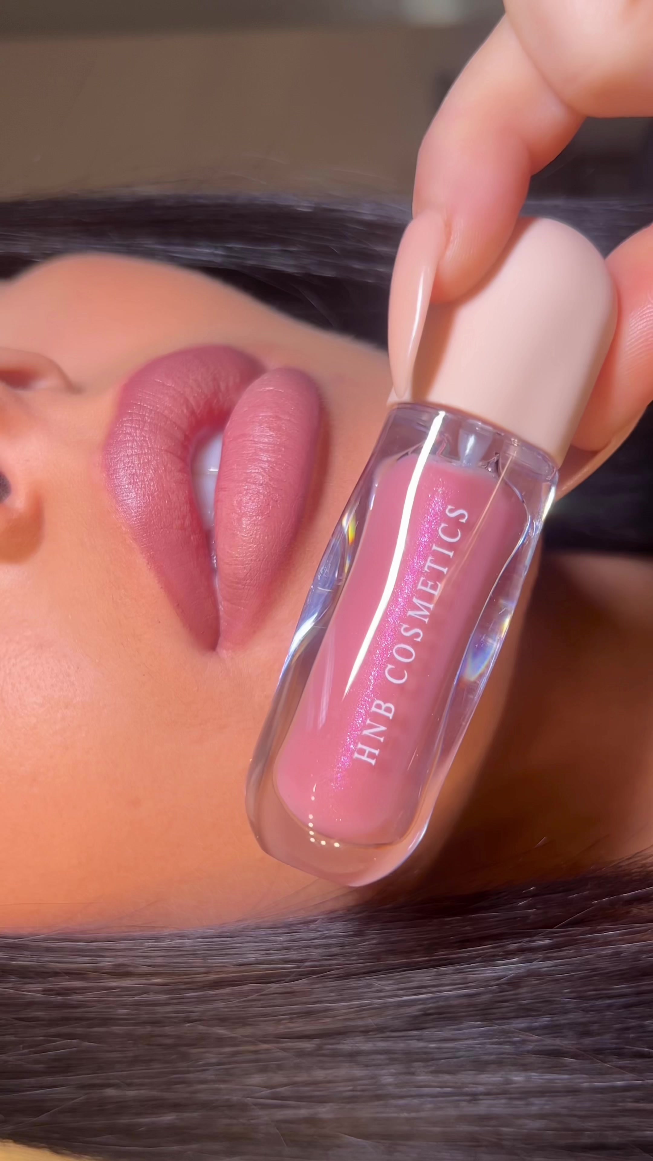 TikTok post by @emmamakeup_x for HNB Cosmetics. Caption reads: NEW lipgloss shade from @HNB Cosmetics in shade....