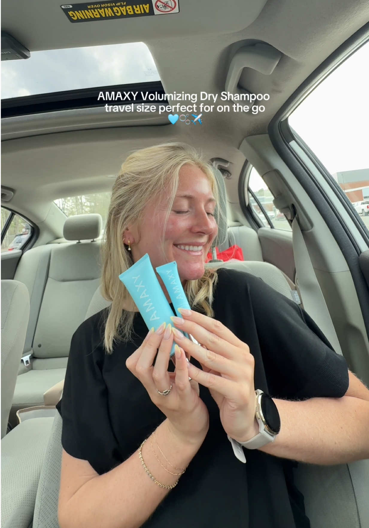 TikTok post by @kaitlinbrown25 for AMAXY Beauty. Caption reads: [...] 🩵💆🏼‍♀️✈️ @AMAXY Haircares #amaxy....