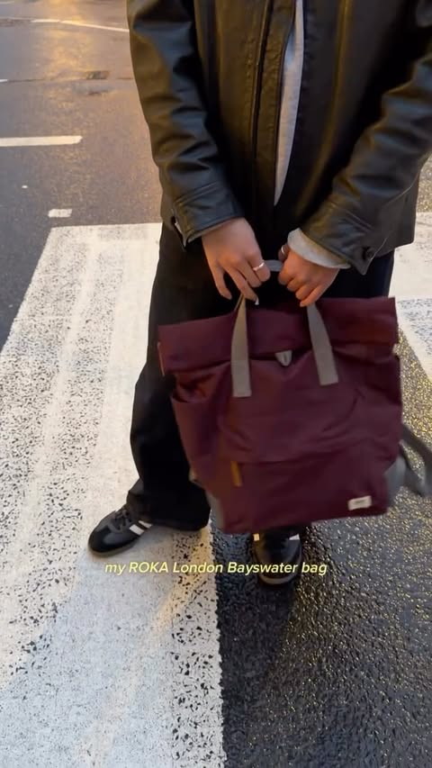 Instagram post by @where.nel.eats for ROKA London. Caption reads: AD | a bag made for London weather: the perfect....