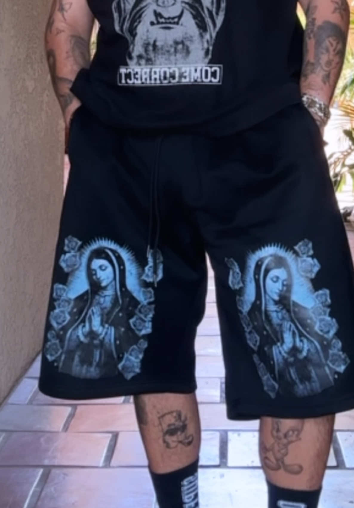 TikTok post by @trinoandadam for FB COUNTY CLOTHING. Caption reads: Check out these bad ass shorts that I got from FB....