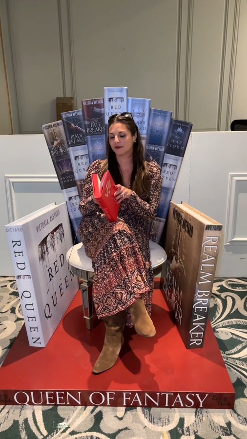 Instagram post by @victoriaaveyard for Epic Reads. Caption reads: kept your throne warm for you @victoriaaveyard 😇.