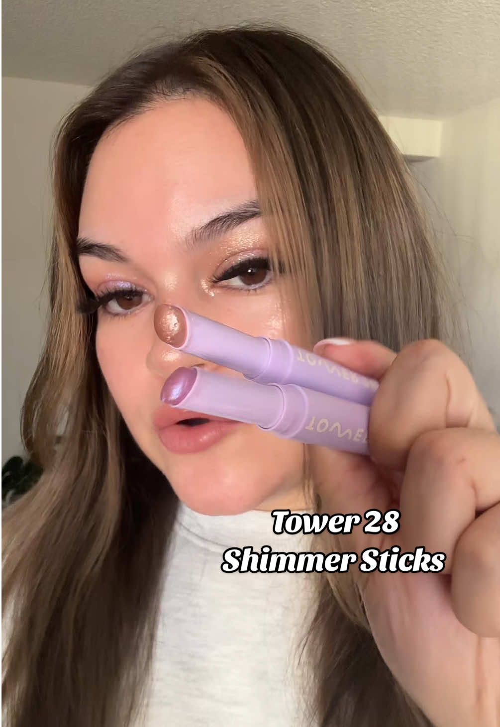 TikTok post by @julesbbeauty for Tower 28 Beauty. Caption reads: [...] cooling shimmer sticks by @Tower 28 Beauty 8....