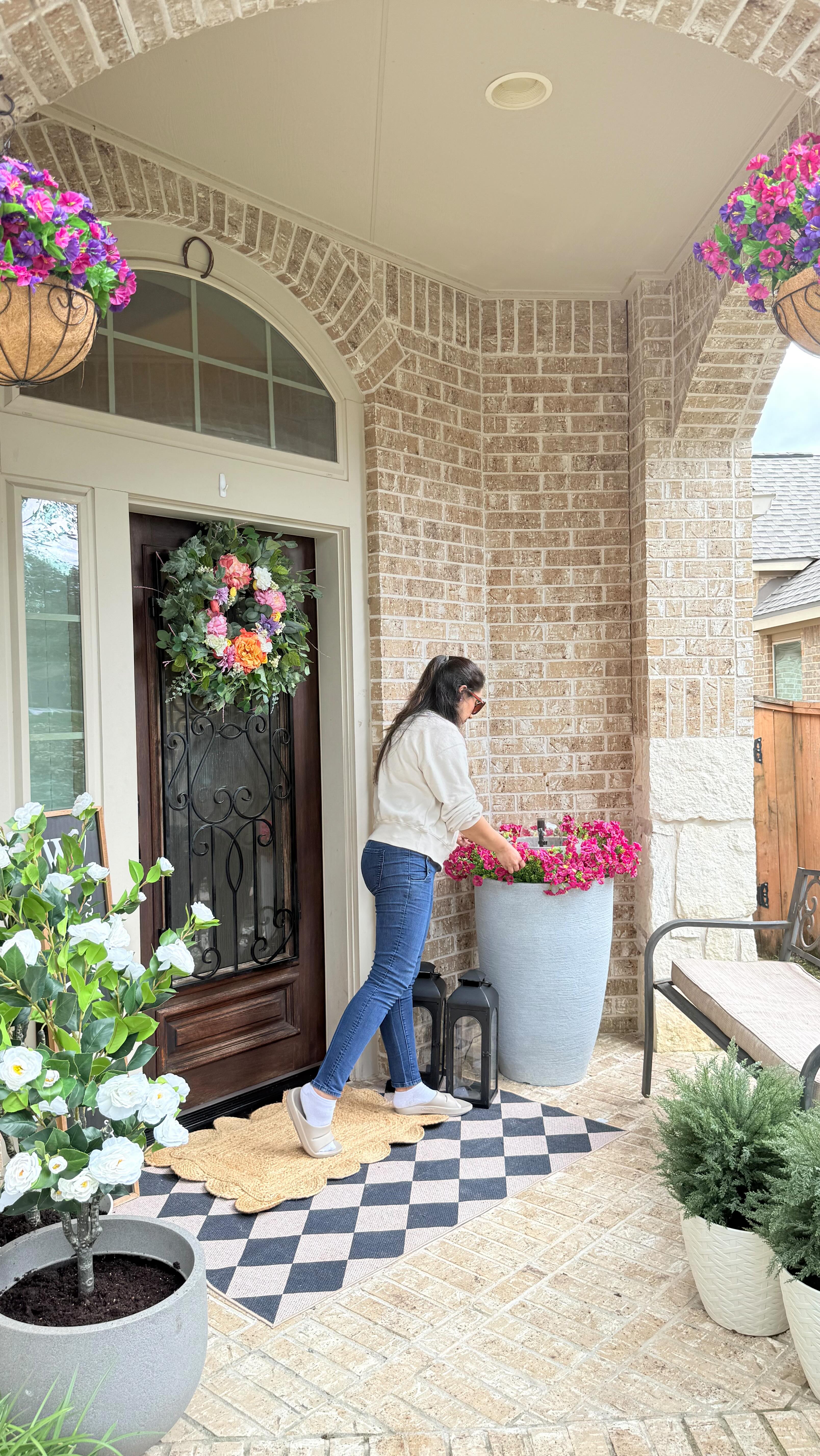Instagram post by @the_aesthetic_side_of_homes for OOFOS. Caption reads: I wanted to refresh our front porch… but ended up....