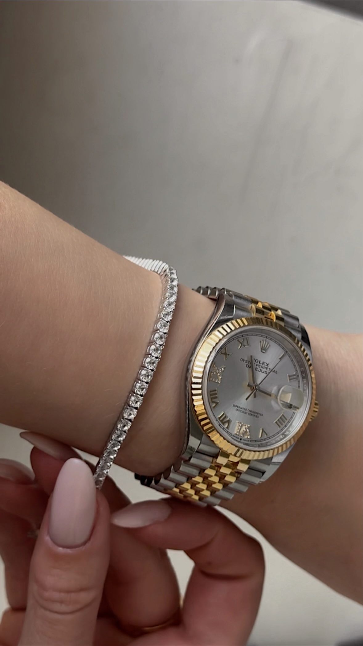 Instagram post by @kokobeaute for Aurate New York. Caption reads: stack it with the watch, or wear it solo on the....