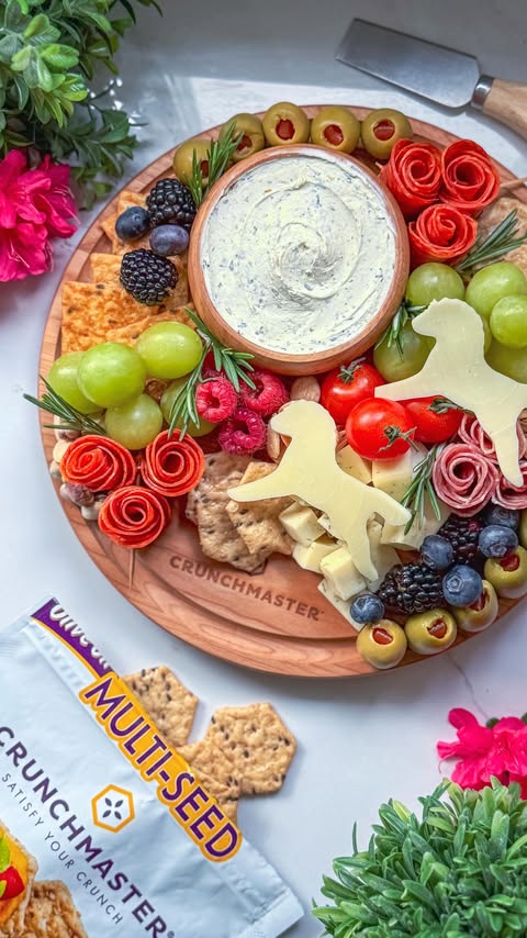 Instagram post by @charcuterie_n_things for Crunchmaster Crackers. Caption reads: [...] it a snack board 🤎🏇 Crunchy....