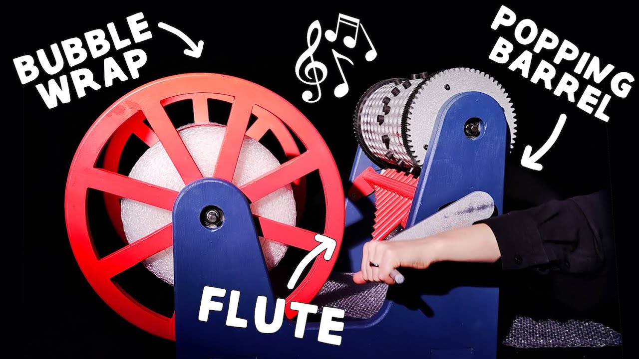 YouTube post by @simonegiertz for Qualcomm. Caption reads: This machine plays songs by popping bubble wrap.