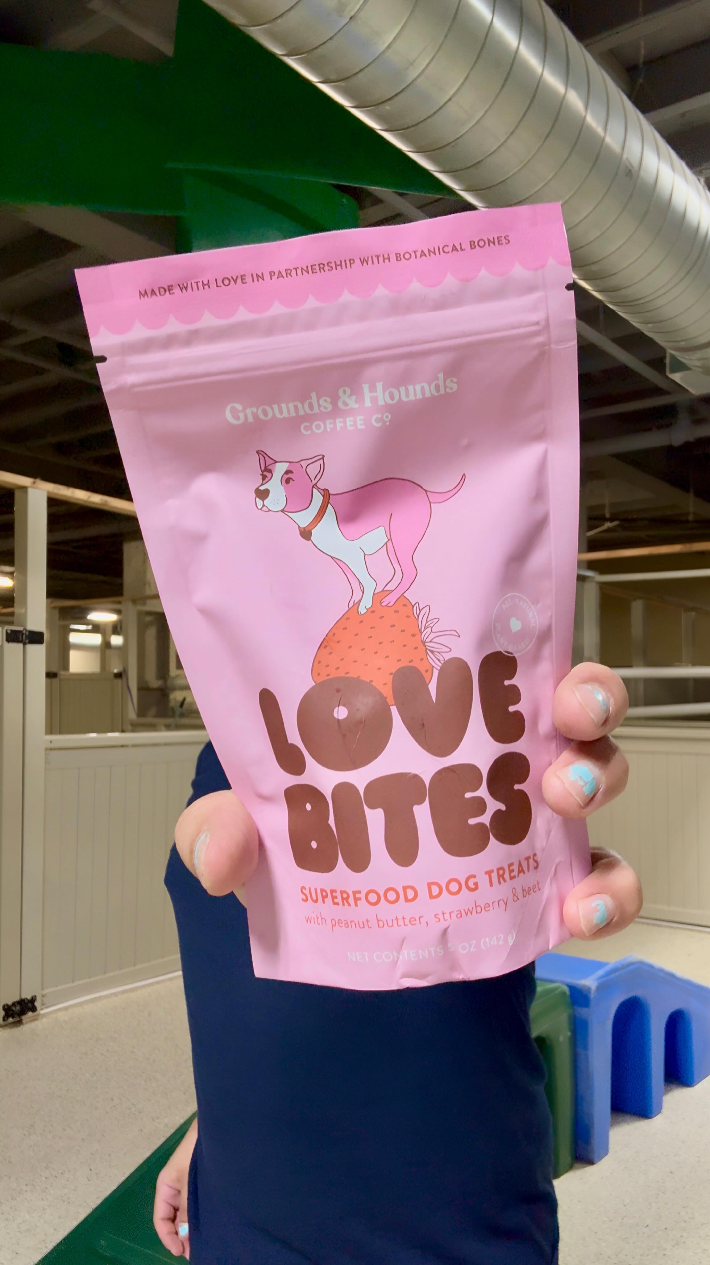 Instagram post by @botanicalbonesco for Grounds & Hounds Coffee Co.. Caption reads: Surprising dogs with Love Bites at dog....