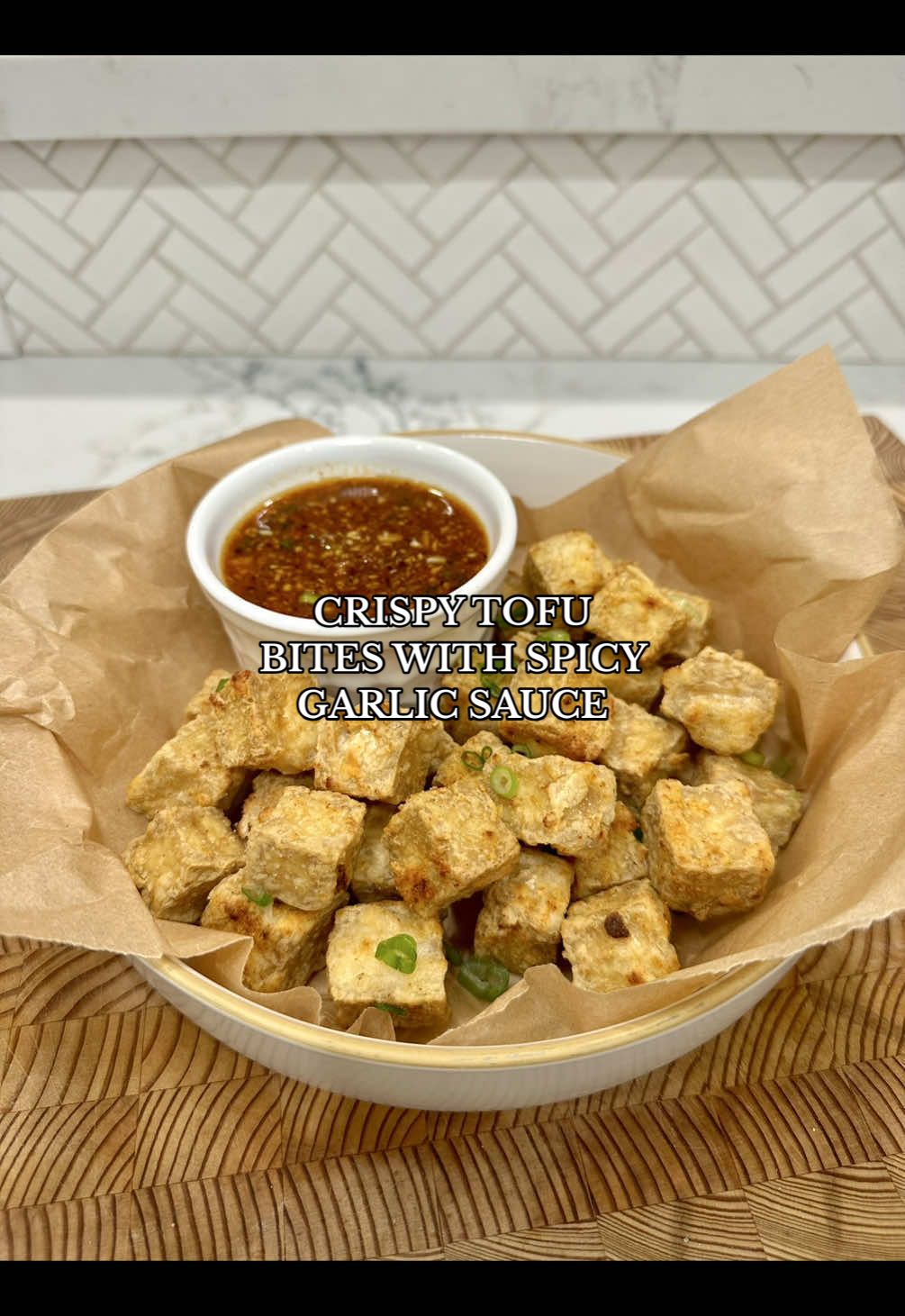 TikTok post by @thespicyjuju for Instant Pot. Caption reads: Crispy Tofu Bites with Spicy Garlic Sauce 🌶️🧄....