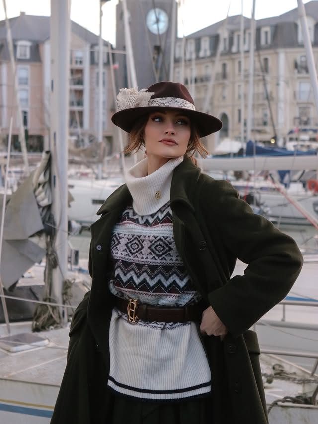 Instagram post by @minakshi.mahta for Holland Cooper. Caption reads: [...] @sarahrossmillinery 
Sweater, belt....