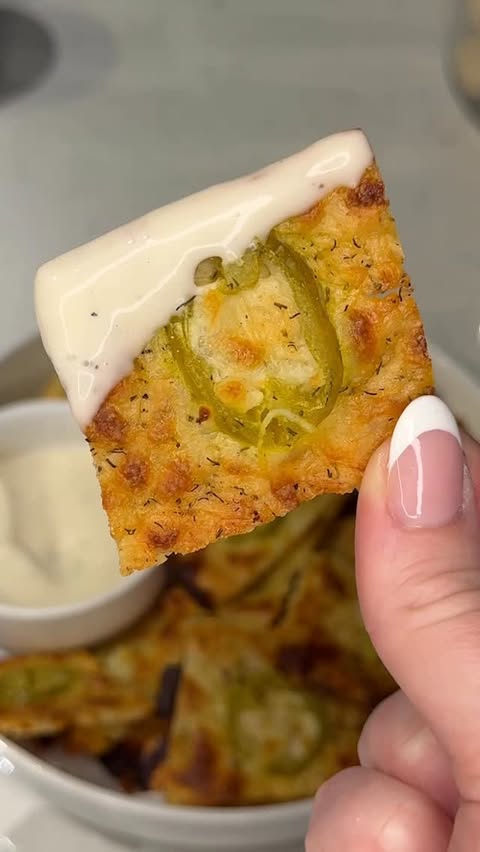Instagram post by @ashleymarkleeats for Mezzetta. Caption reads: these crispy parmesan jalapeño chips are about to....