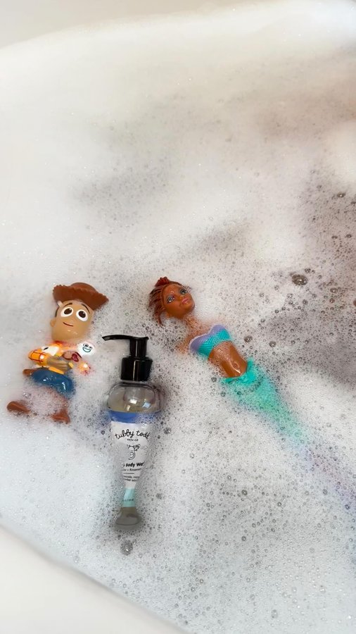 Instagram post by @travelinnjenn for Tubby Todd. Caption reads: Something about those little giggles and bubbles....