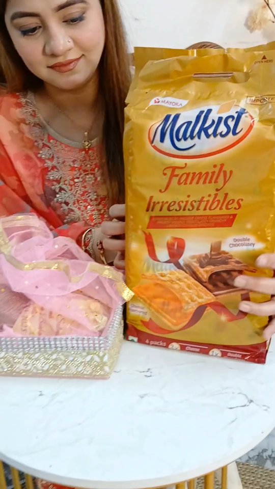 Instagram post by @exquisite_quratinz for Malkist Premium Crackers. Caption reads: Not just a gift. It’s a bite of childhood, love &....