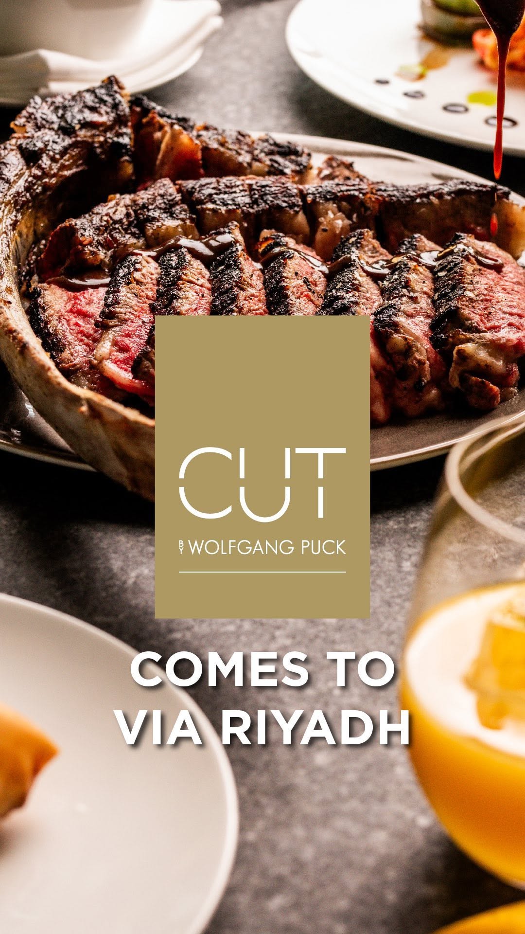 Instagram post by @wolfgangpuck for Visit Saudi. Caption reads: Experience CUT by @wolfgangpuck at @viariyadh....