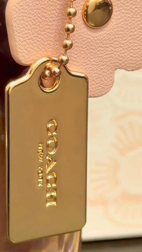 Instagram post by @thehijjabigirl1 for Coach. Caption reads: A masterpiece from @coach This perfume is best for....