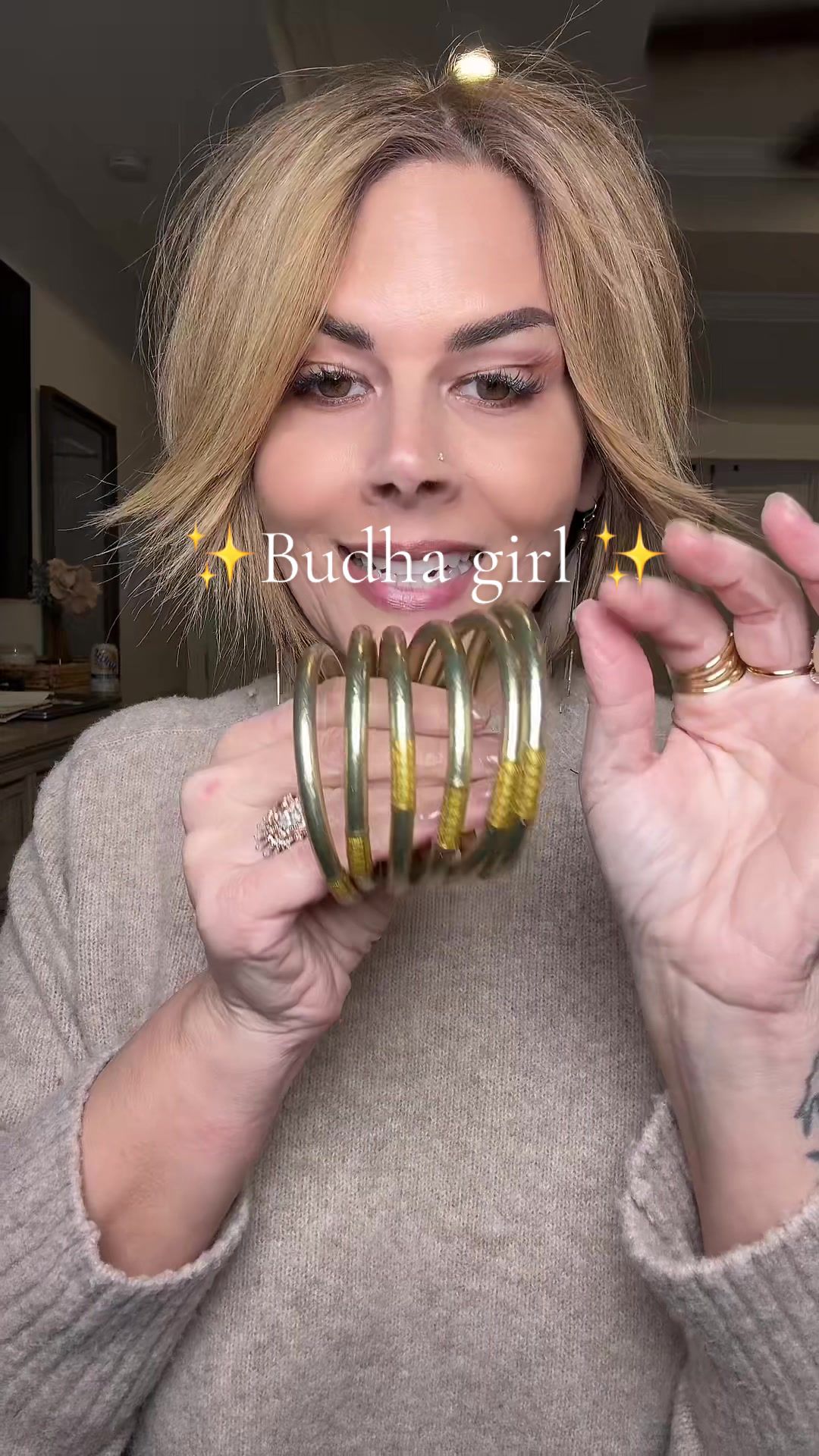 TikTok post by @jennifer.mire for BuDhaGirl. Caption reads: @BuDhaGirl how I style my #budhagirl #jewelrystack....