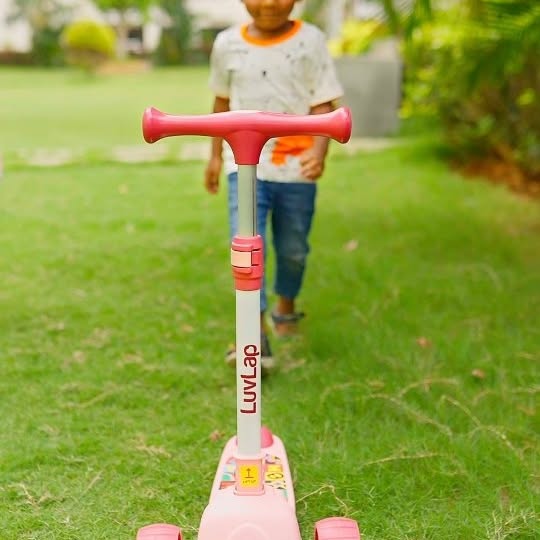 Instagram post by @hema.gayatri for LuvLap. Caption reads: 🛴✨ Glide into fun with the LuvLap Elegant....