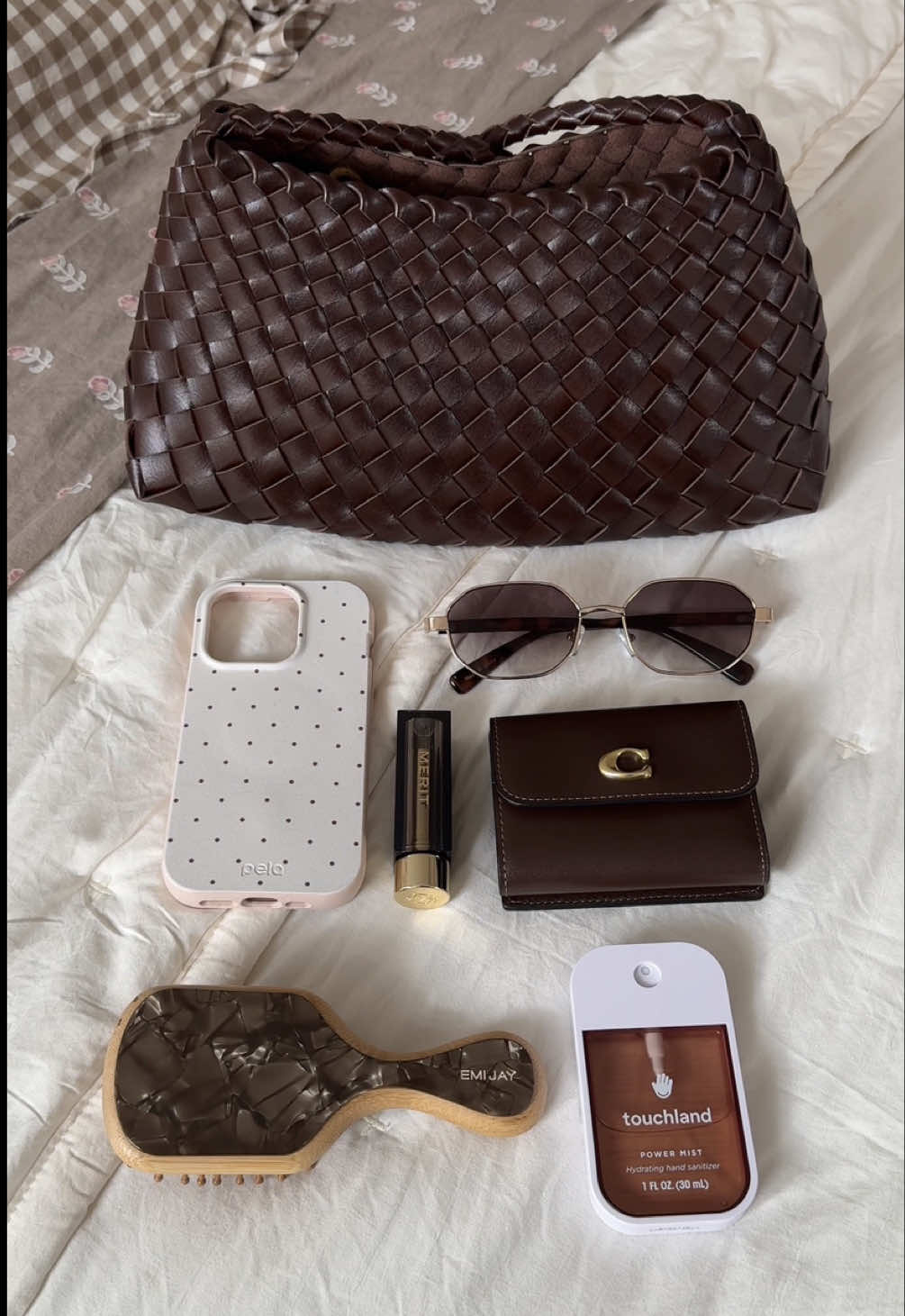 TikTok post by @clauivory for Emi Jay. Caption reads: [...] @target @Coach @MERIT Beauty @Emi Jay....