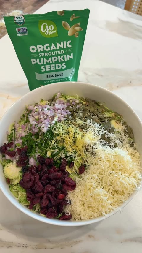 Instagram post by @thedailyschvitz for Go Raw. Caption reads: This shaved Brussels sprout salad with @go_raw....