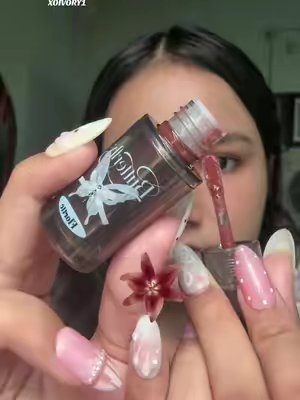 TikTok post by @ivy_rnnn for Flortte Beauty. Caption reads: @FLORTTE Beauty Twin Butterfly Series Lip serum....