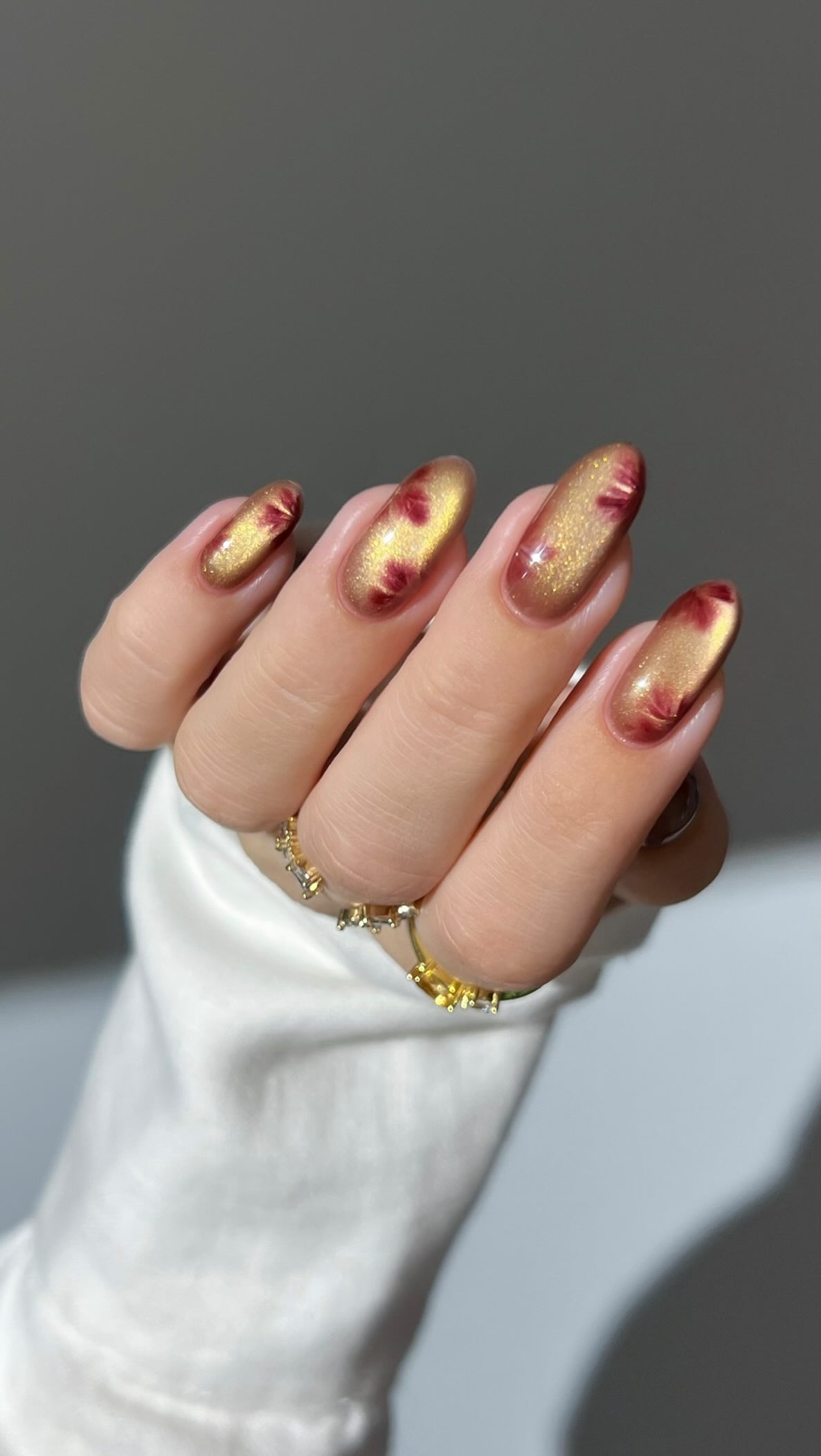 Instagram post by @heygreatnails for Modelones. Caption reads: 🍷🍁 glassy beige with burgundy maple leaves ✨....