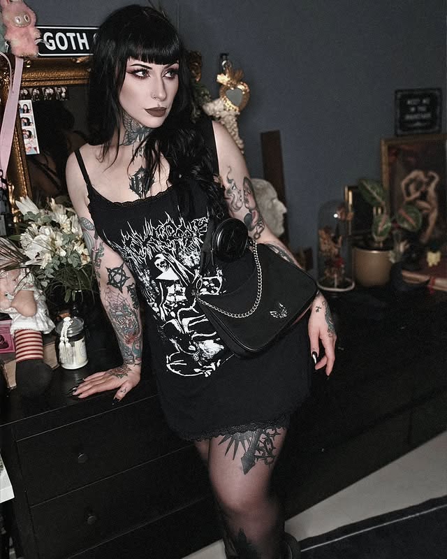 Instagram post by @debbythestrange_ for Blackcraft Cult. Caption reads: [...] 𝔱𝔥𝔢 𝔤𝔯𝔞𝔳𝔢𝔶𝔞𝔯𝔡 ⚰️🥀 👗👜....