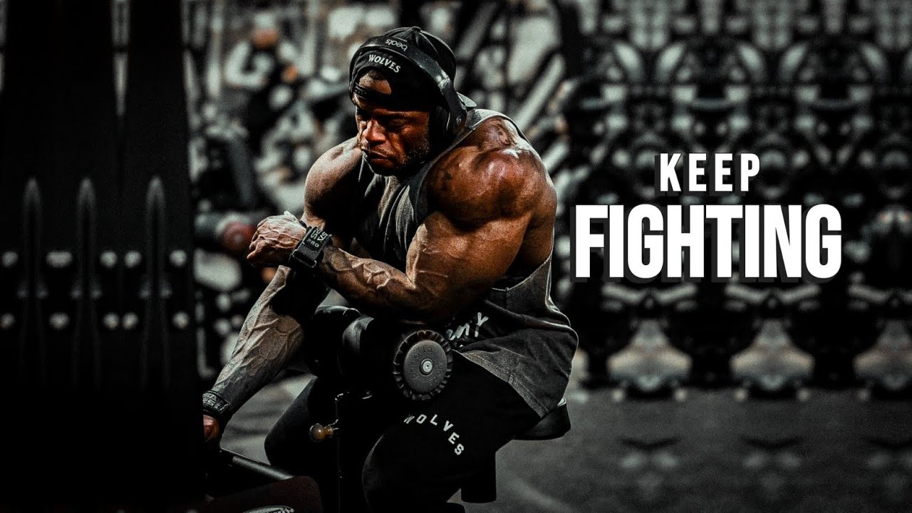 YouTube post by @MuscleBrawn for ENHANCED Labs. Caption reads: GET UP & KEEP FIGHTING 💪 Gym Motivation.