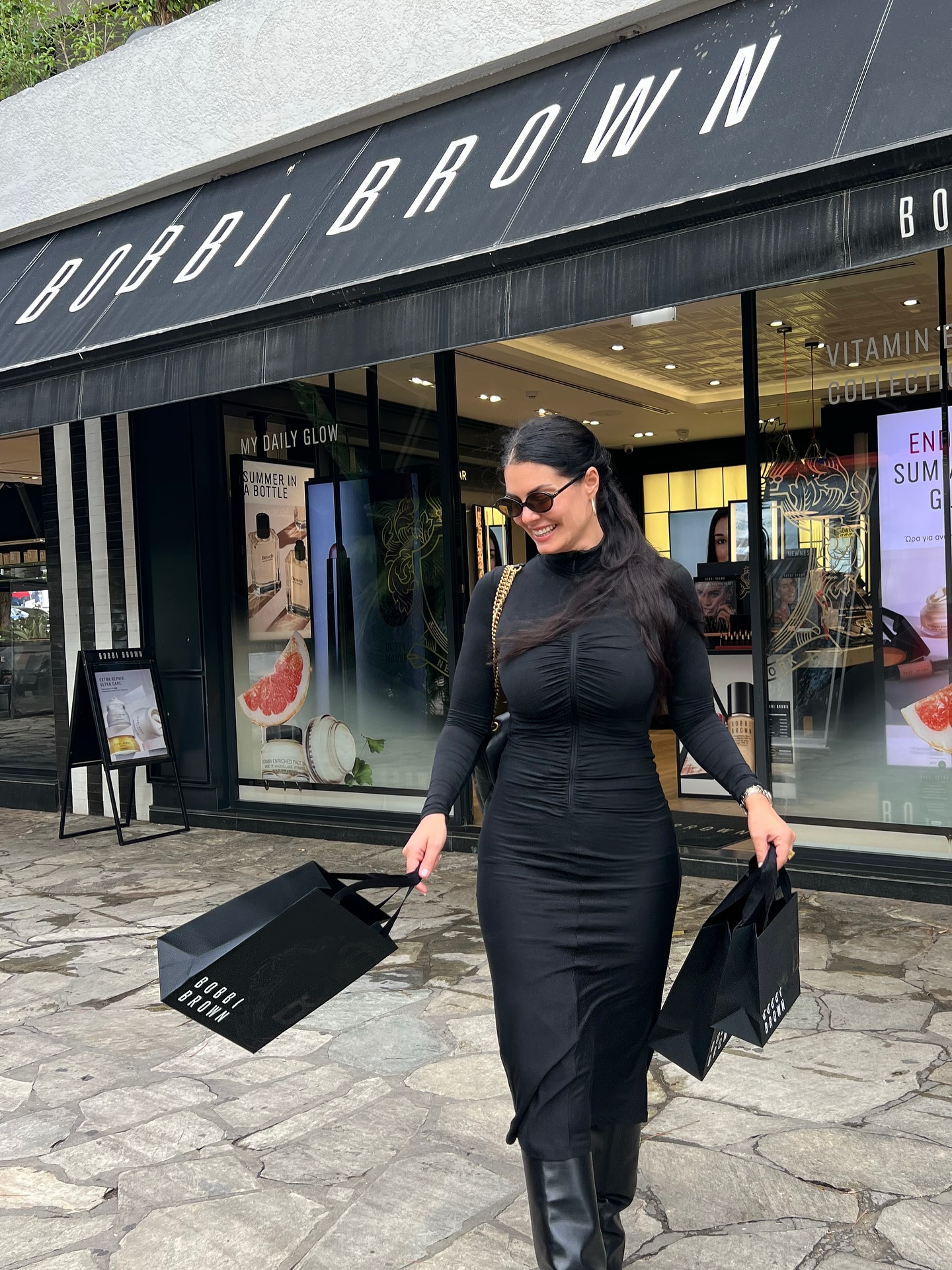 Instagram post by @mariakorinthiou for Bobbi Brown Cosmetics. Caption reads: @bobbibrown 🖤

Dress @pinkoofficial  @pinkogreece....