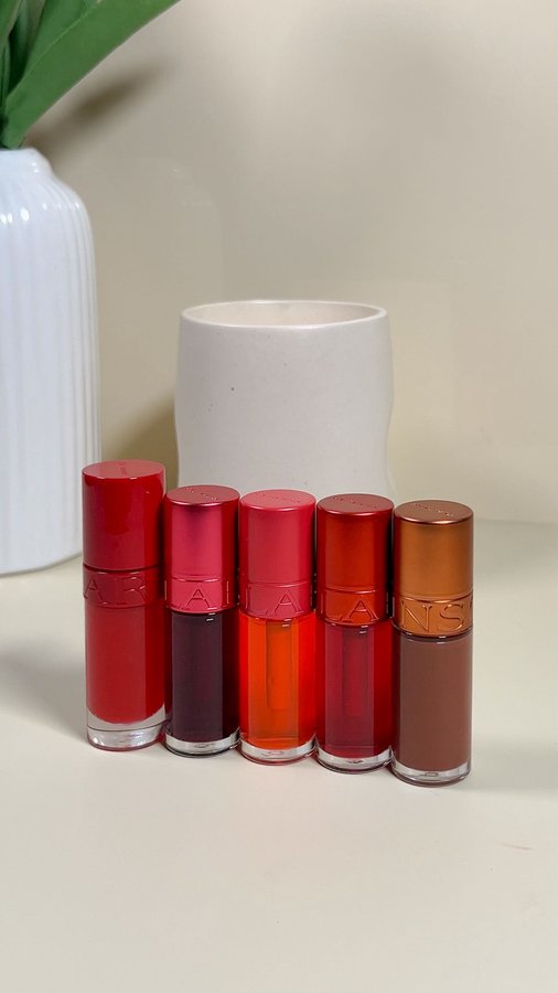 Instagram post by @dewydisposition for Clarins. Caption reads: Gifted by Clarins. Lip game = next level!....